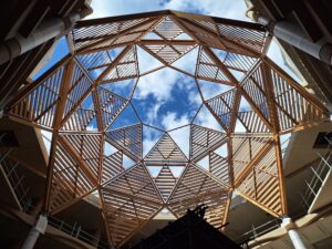 The timber dome erected with brise-soleil panels partially erected